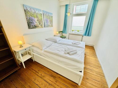 a small bedroom with a bed and a window at Seerose in Warnemünde