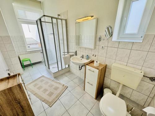 a bathroom with a toilet and a sink at Seerose in Warnemünde