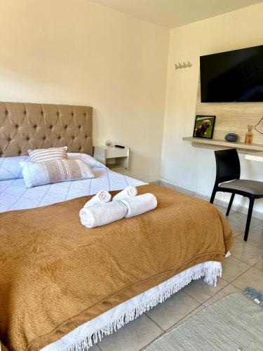 a bedroom with two towels sitting on a bed at Lo de Nacho in Canning