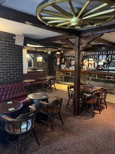 a restaurant with tables and chairs and a bar at Moorville Hall Hotel in Stoke on Trent