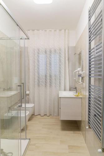 a bathroom with a sink and a toilet and a shower at Al Solito Posto Affittacamere in Alianello