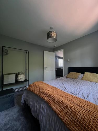 a bedroom with a large bed and a large mirror at Two bed flat in Cardiff in Cardiff