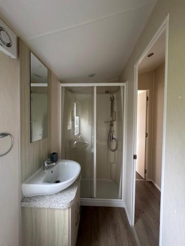 a bathroom with a sink and a shower at Newquay Bay Resort getaway in Porth