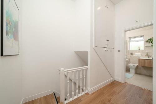 a white bathroom with a sink and a toilet at Large 4BR Contractor-Friendly House - Sleeps 10 - Free parking - North London in Enfield