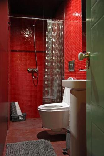 a bathroom with a shower and a toilet and a sink at 29 Madeira Hostel in Funchal