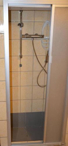 a shower with a glass door in a bathroom at Charming Belgian Getaway, vakantiewoning in Oudsbergen - 3 Bedrooms Garden in Oudsbergen 