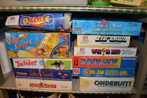 a pile of games on a shelf at Charming Belgian Getaway, vakantiewoning in Oudsbergen - 3 Bedrooms Garden in Oudsbergen 