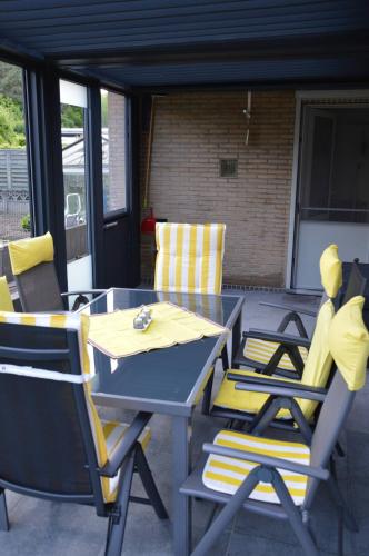 a table and chairs sitting on a patio at Charming Belgian Getaway, vakantiewoning in Oudsbergen - 3 Bedrooms Garden in Oudsbergen 