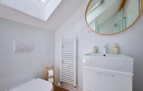 a white bathroom with a sink and a mirror at Villa River home by WH by Villas Guide 