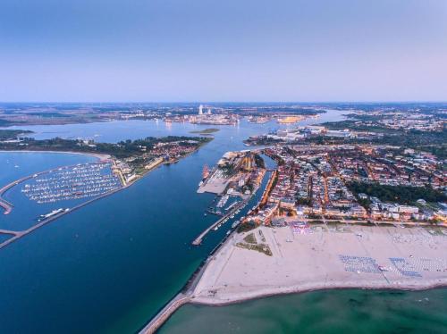 an aerial view of a beach and a harbor at Landhaus Immenbarg, Wellness in Warnemünde