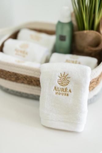 a white towel with a nirvana house logo on it at Auréa House - 4BR Azores Villa with Ocean View, BBQ & AC in Feteiras