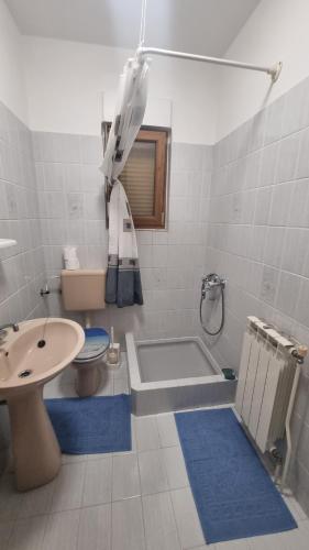 a bathroom with a tub and a toilet and a sink at Apartments DEXI in Banjol