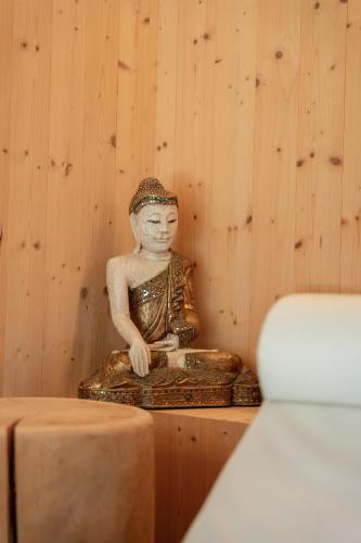 a statue of a man sitting on a table at Camping Olympia in Dobbiaco