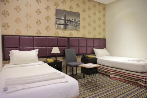 Voodi või voodid majutusasutuse Snood Al Baraka Hotel toas