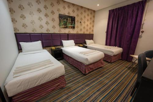 Postel nebo postele na pokoji v ubytování Snood Al Baraka Hotel
