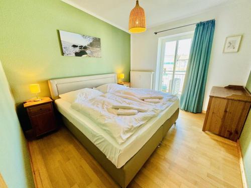 a bedroom with a bed and a large window at Haus Juliane, Seesand in Warnemünde