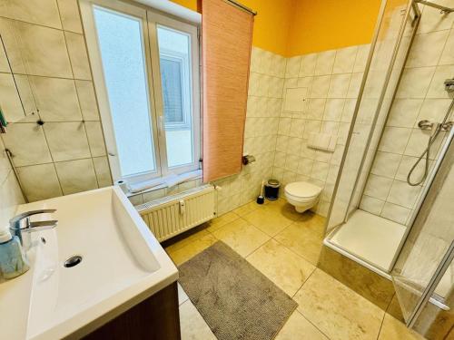 a bathroom with a sink and a shower and a toilet at Haus Juliane, Seesand in Warnemünde