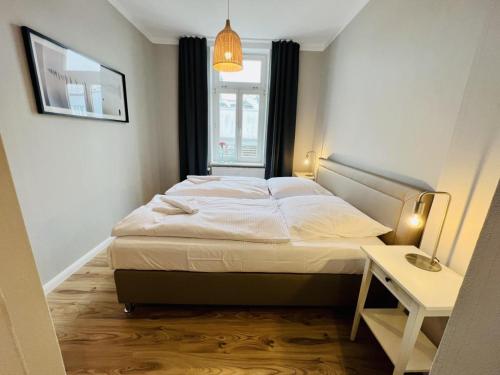 a bedroom with a bed in a room with a window at Haus Juliane, Neptun in Warnemünde