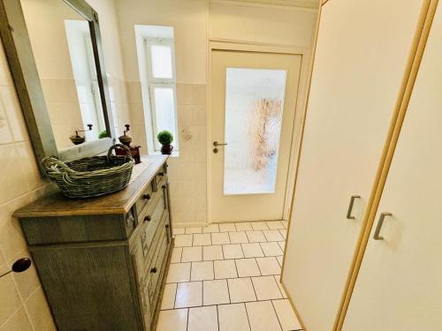 a bathroom with a sink and a mirror at Appartement Sonnenflut in Warnemünde