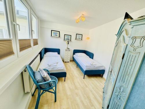 a room with two beds and a window at Appartement Sonnenflut in Warnemünde