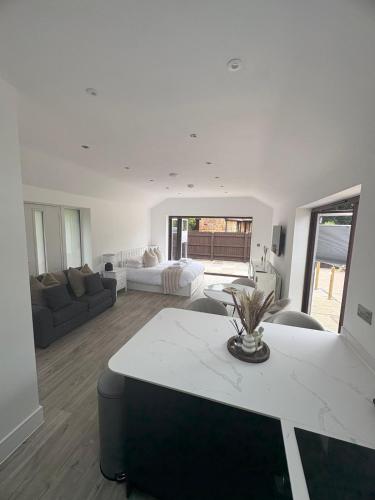 a living room with a couch and a table at Portbridge Nest in Chew Magna