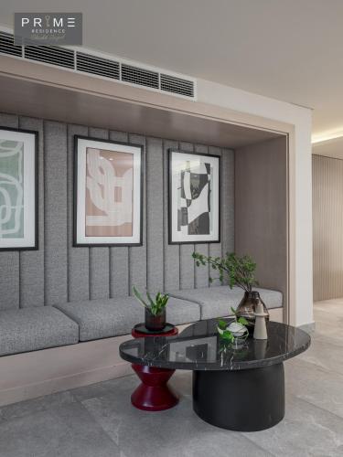 a living room with a couch and a table at Prime Residence Sheikh Zayed in Sheikh Zayed