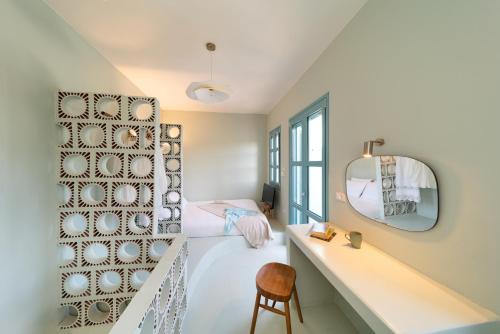 a bedroom with a sink and a mirror and a bed at Via Vasileia in Kattavía