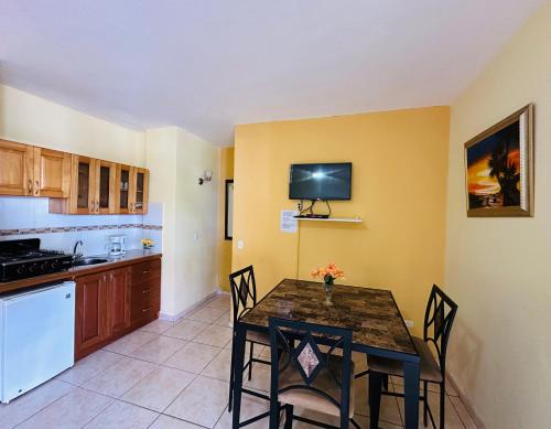a kitchen and dining room with a table and chairs at Aparthotel Michaela in Sosúa