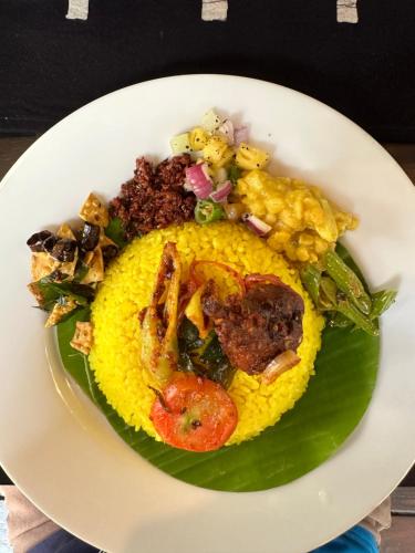 a plate of food on top of a green leaf at Turtle Pond Wilpattu in Wilpattu