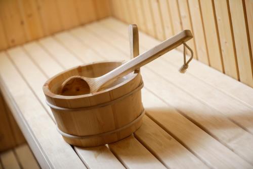 a wooden spoon in a wooden bucket on a wooden floor at Best Western Plus Hotel Eyde in Herning