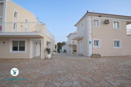 a row of houses on a stone courtyard at La SkalaVista in Skala Kefalonias