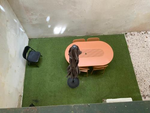 an overhead view of a table and chairs on a green floor at appartement avec patio vielle Antibes in Antibes