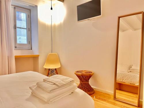 a bedroom with a bed and a mirror at Loureiro 59 in Coimbra