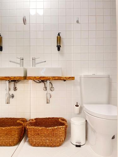 a bathroom with a toilet and a sink at Loureiro 59 in Coimbra