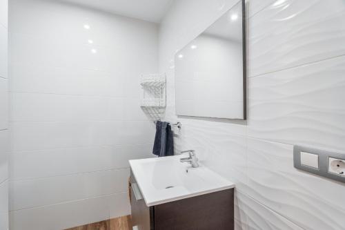 a white bathroom with a sink and a mirror at Casa Rural Tijoco in Adeje