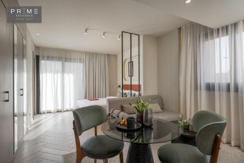 a living room with a table and a couch at Prime Residence Sheikh Zayed in Sheikh Zayed