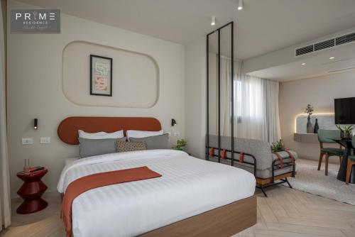 a bedroom with a large bed and a living room at Prime Residence Sheikh Zayed in Sheikh Zayed