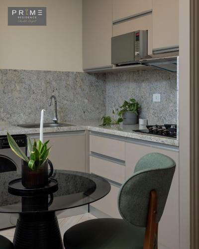 a kitchen with a table with a candle on it at Prime Residence Sheikh Zayed in Sheikh Zayed