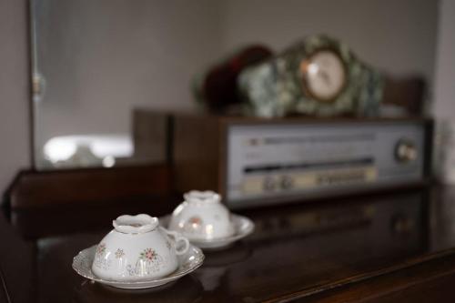 two tea cups sitting on top of a table at Beb La Patataia Home in Bormida