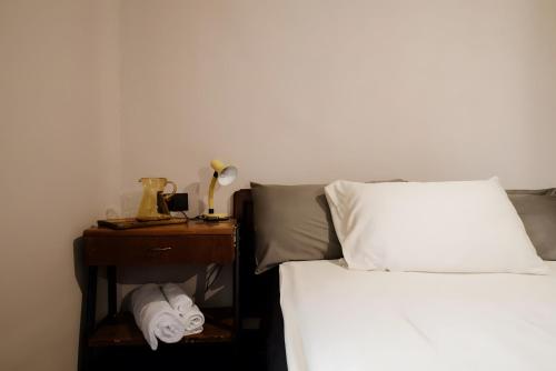 a bedroom with a bed and a nightstand next to a bed at Beb La Patataia Home in Bormida