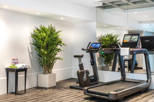 a fitness room with a treadmill and plants at Maison Albar - Le Diamond in Paris
