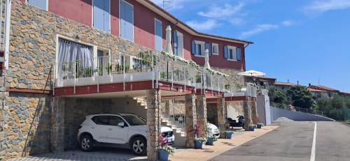 a white car parked in front of a building at Homeliday RELAX in Caldana