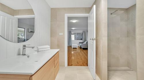 a bathroom with a sink and a mirror at Sam's Beach Shack and Apartment in Callala Beach