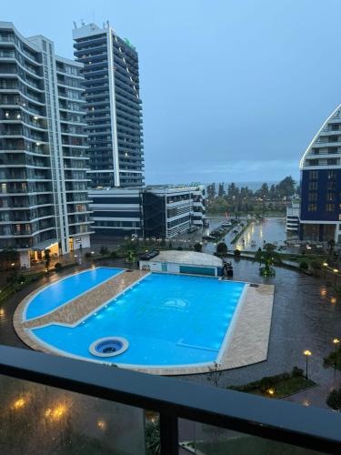 a view from the balcony of a building with a swimming pool at Apartamenti v Batumi in Batumi