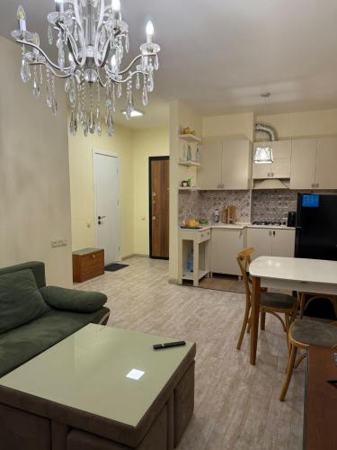 a living room with a couch and a table at Apartamenti v Batumi in Batumi
