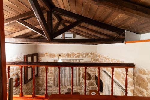 a room with stone walls and wooden ceilings at Petra Vori Studio in Vóroi