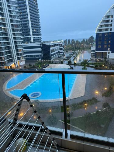 a view of a pool from the balcony of a building at Apartamenti v Batumi in Batumi