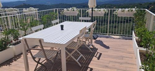 a white table and chairs on a balcony at homeliday ACTIVE in Caldana