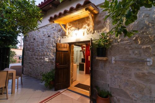 an entrance to a stone building with a wooden door at Petra Vori Studio in Vóroi