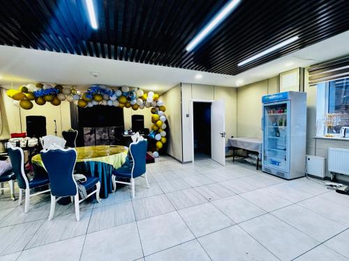 a dining room with a table and chairs and balloons at Lofty Hotel in Ulaanbaatar